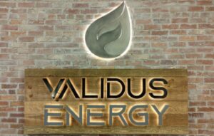 Validus Energy lit sign and lit leaf hanging on a break wall