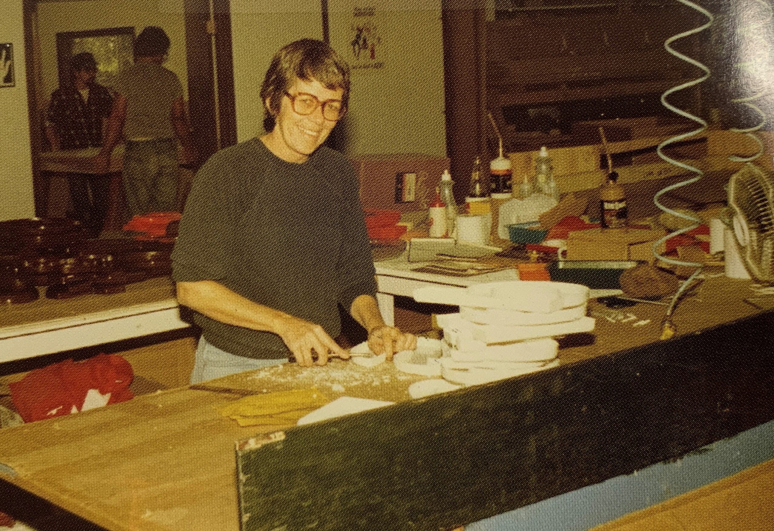 Worker smiling over letter work table