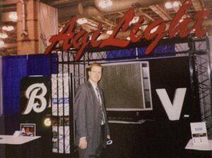 Man standing in front of a tradeshow booth.