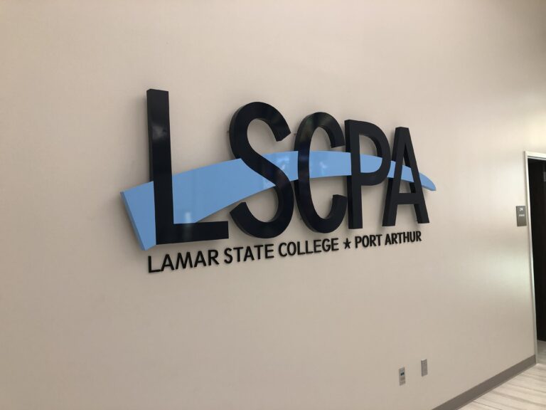 image of flat cut metal sign for Lamar State College on a office wall