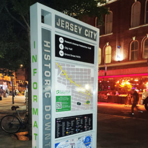 Flat Cut Metal letters assembled on wayfinding signage in busy downtown street. 